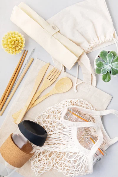 Zero waste concept. Set of eco friendly bamboo cutlery, mesh cotton bag, reusable coffee tumbler. Sustainable, ethical shopping, plastic free lifestyle — Stock Photo, Image