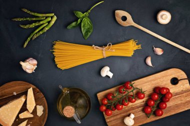 İtalyan makarnası pişirmek için gerekli malzemeler. Spagetti, domates, yağ, sarımsak, parmezan. Geleneksel italyan kümes konseptinin en üst görüntüsü