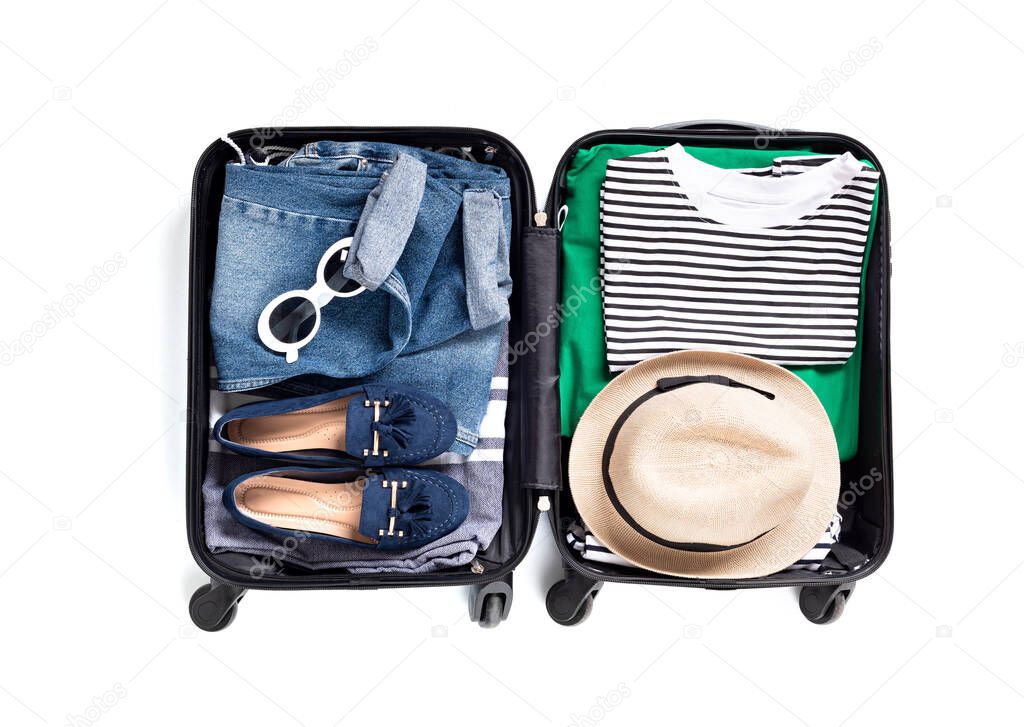 Flat lay with open suitcase with casual clothes for summer vacations over white background. Summer holidays, travel, tourism, flight luggage concept. Top view