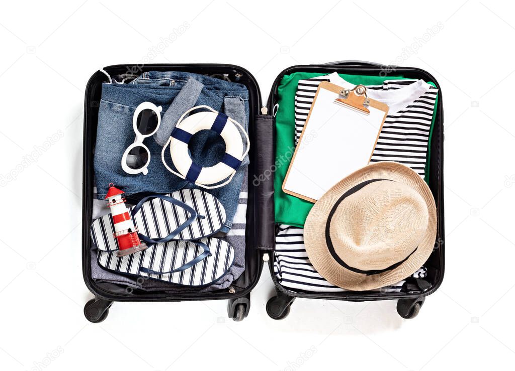 Flat lay with open suitcase with casual clothes for summer vacations over white background. Summer holidays, travel, tourism, flight luggage concept. Top view