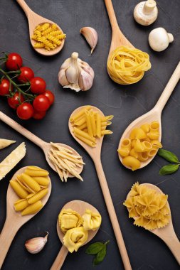 Geleneksel İtalyan makarnasının farklı türleriyle yatıyordu. Penne, tagliatelle, fusilli, farfalle, spagetti ve yemek malzemeleri. Geleneksel italyan kümes konsepti. Üst görünüm