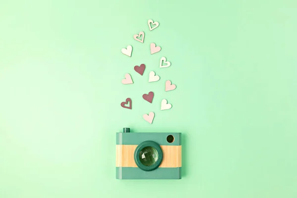 Flat lay with toy wooden camera and hearts. Social media, posts, likes, followers, online photography classes concept. Top view, copy space.