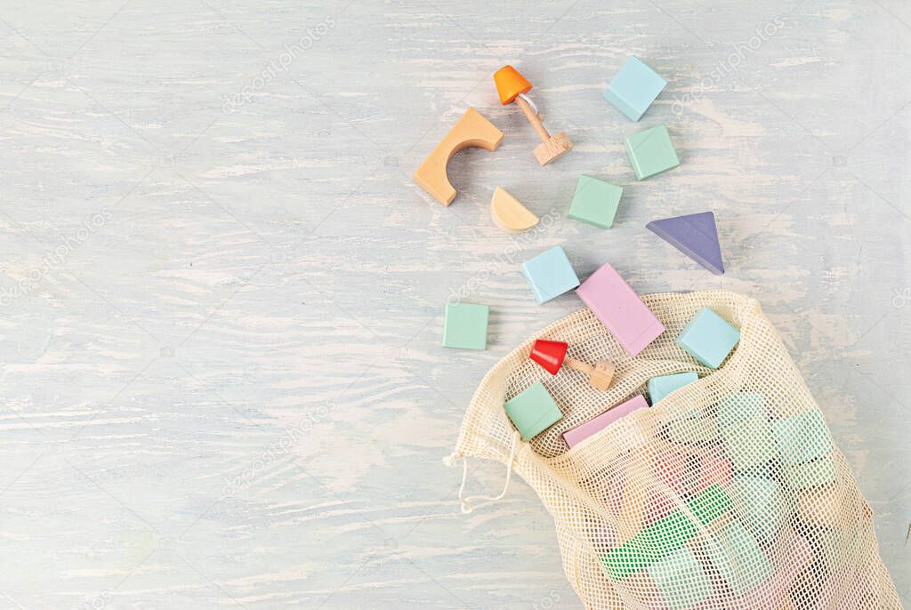 Flat lay with wooden  blocks in pastel colors. Eco friendly, zero waste, plastic free, educational, gender neutral toys for children. Copy space, top view