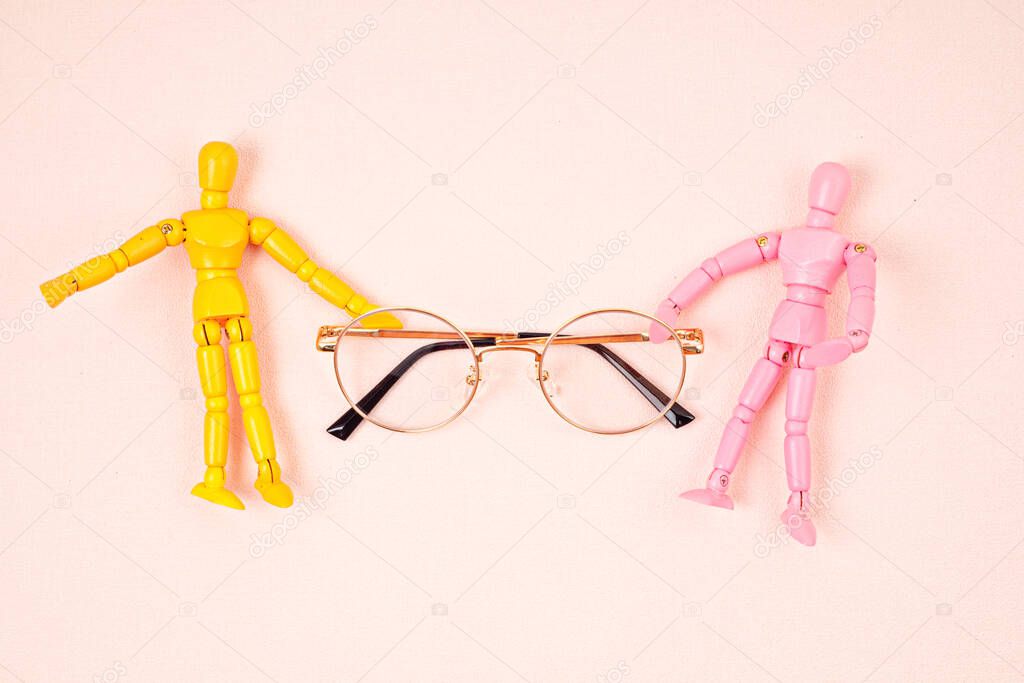 Flat lay with to maniquins holding eye glasses. Eye vision check concept. Top view