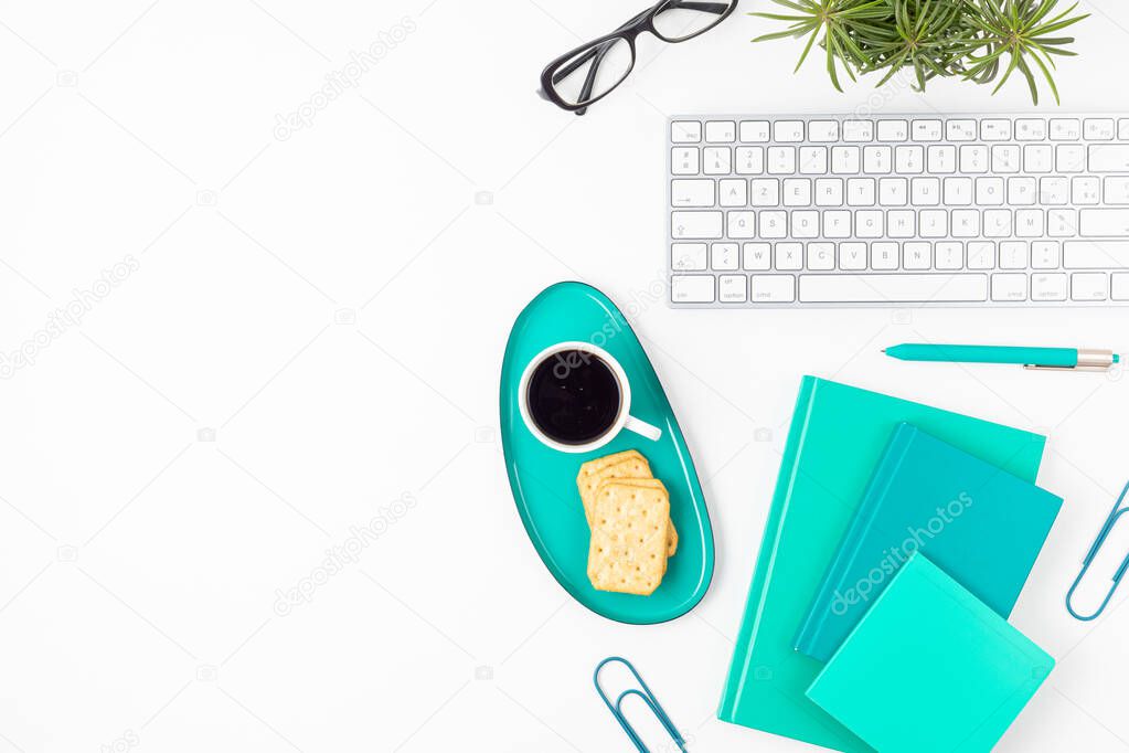 Top view of home office desk. Table with lkeyboard, coffee and stationaries. Flat lay home office workspace organization, remote work, distant learning, video conference, calls concept 