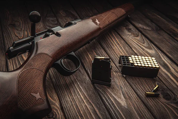 Classic bolt carbine .22lr with a wooden butt on a dark wooden s — Stock Photo, Image