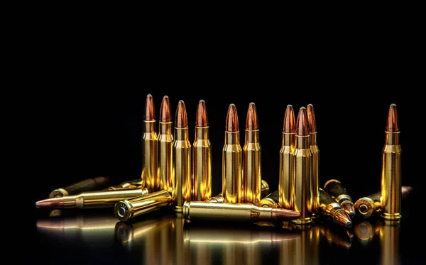Bullet isolated on black background with reflexion. Rifle bullet