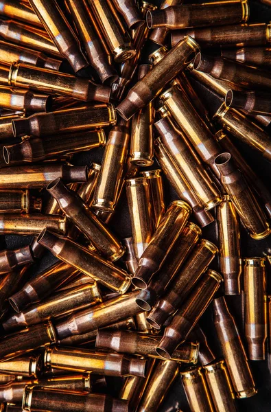 Background from empty cartridges for rifles and carbines. Shiny — Stock Photo, Image