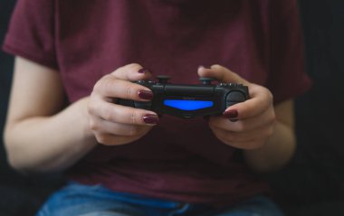 Ukraine, Odessa  July 2, 2019: A girl plays a video game on a p