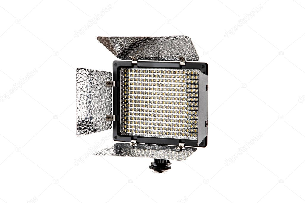 Photo and video lamp isolate on white background. LED lamp with special shutters for the formation of light flux. Photo and video lighting fixture.