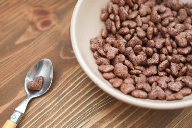 Cornflake kalp şeklinde ahşap kahverengi zemin kaşık yatıyor