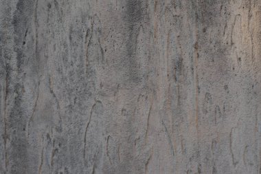 Structural gray aged stucco on the facade of the house. Creative