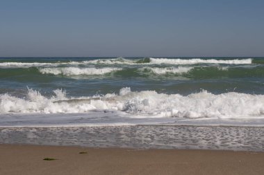 Deniz, deniz dalgaları ve kıyı şeridi güneşli bir günde
