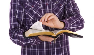 Man holding a Bible, isolated on white background clipart