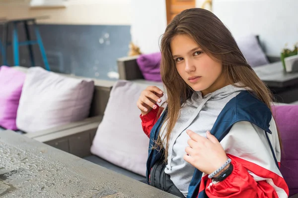 Retrato de jovem atraente bonito adolescente olhando para câmera sorrindo com conceito de estilo de vida urbano no café ao ar livre. Colar um tolo . — Fotografia de Stock