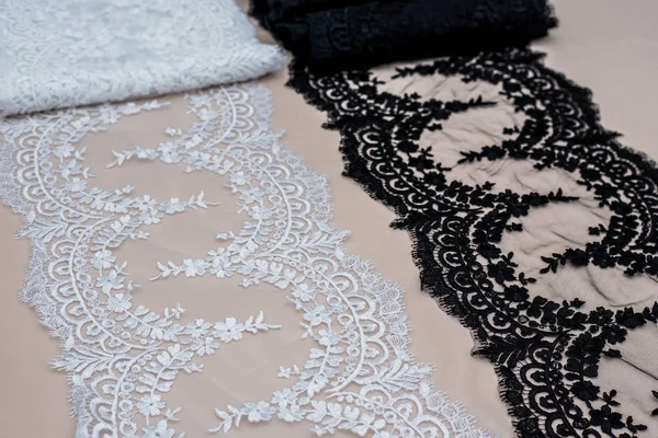 Texture lace fabric. lace on white background studio. thin fabric made of yarn or thread. a background image of ivory-colored lace cloth. White, black and beige lace on beige background. — Stock Photo, Image