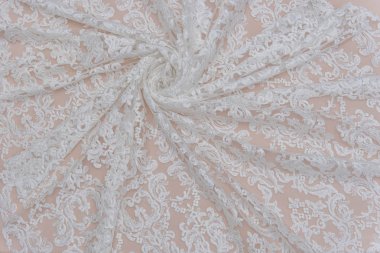 Fildişi renkli dantel kumaşın arkaplan resmi. Bej arkaplanda beyaz dantel.