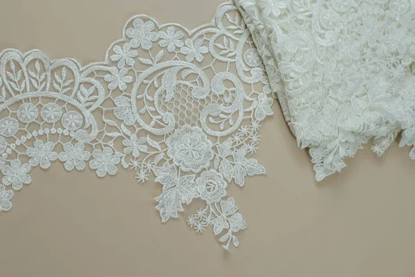 Texture lace fabric. lace on white background studio. thin fabric made of yarn or thread. a background image of ivory-colored lace cloth. White lace on beige background. — Stock Photo, Image
