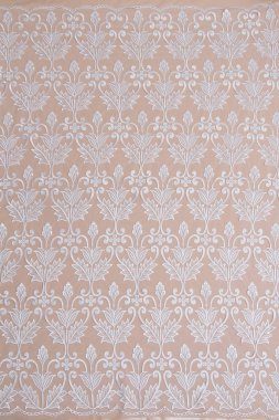 Fildişi renkli dantel kumaşın arkaplan resmi. Bej arkaplanda beyaz dantel.