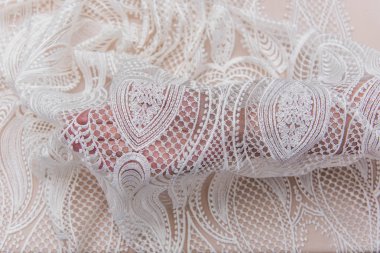 Fildişi renkli dantel kumaşın arkaplan resmi. Bej arkaplanda beyaz dantel.