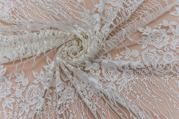 Texture lace fabric. lace on white background studio. thin fabric made of yarn or thread. a background image of ivory-colored lace cloth. White lace on beige background.