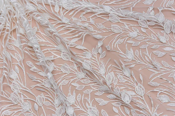 Texture lace fabric. lace on white background studio. thin fabric made of yarn or thread. a background image of ivory-colored lace cloth. White lace on beige background. — Stock Photo, Image
