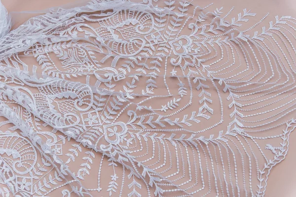 Texture lace fabric. lace on white background studio. thin fabric made of yarn or thread. a background image of ivory-colored lace cloth. White lace on beige background. — Stock Photo, Image