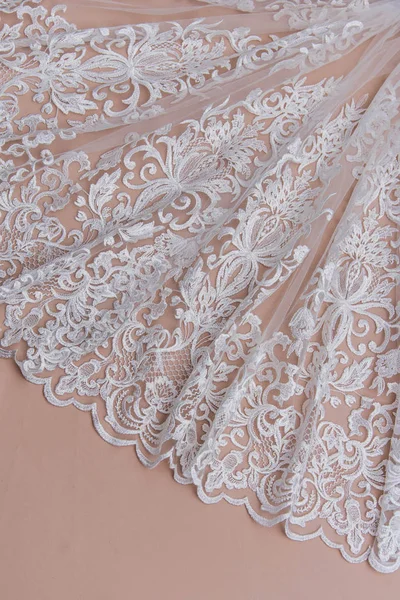 Texture lace fabric. lace on white background studio. thin fabric made of yarn or thread. a background image of ivory-colored lace cloth. White lace on beige background. — Stock Photo, Image