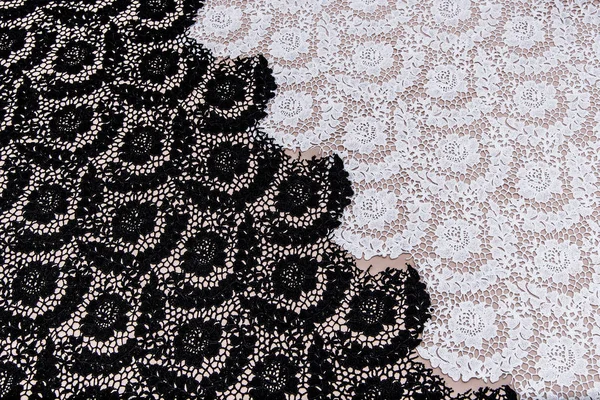 Texture lace fabric. lace on white background studio. thin fabric made of yarn or thread. a background image of ivory-colored lace cloth. White, black and beige lace on beige background.
