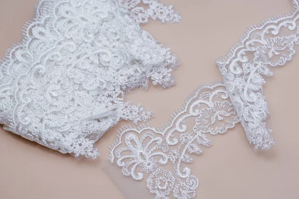 Texture lace fabric. lace on white background studio. thin fabric made of yarn or thread. a background image of ivory-colored lace cloth. White lace on beige background. — Stock Photo, Image