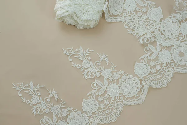 Texture lace fabric. lace on white background studio. thin fabric made of yarn or thread. a background image of ivory-colored lace cloth. White lace on beige background. — Stock Photo, Image