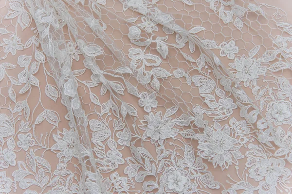 Texture lace fabric. lace on white background studio. thin fabric made of yarn or thread. a background image of ivory-colored lace cloth. White lace on beige background. — Stock Photo, Image