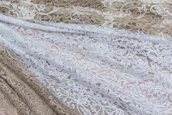 Texture lace fabric. lace on white background studio. thin fabric made of yarn or thread. a background image of ivory-colored lace cloth. White and beige lace on beige background. — Stock Photo, Image