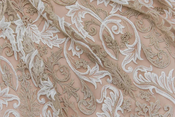 Texture lace fabric. lace on white background studio. thin fabric made of yarn or thread. a background image of ivory-colored lace cloth. White and beige lace on beige background. — Stockfoto