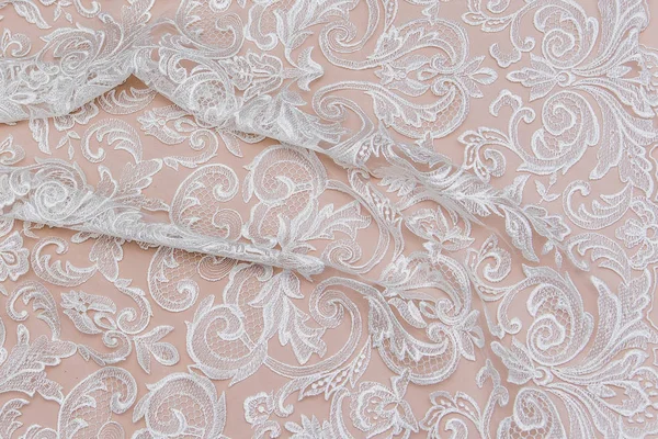 Texture lace fabric. lace on white background studio. thin fabric made of yarn or thread. a background image of ivory-colored lace cloth. White lace on beige background. — Stock Photo, Image