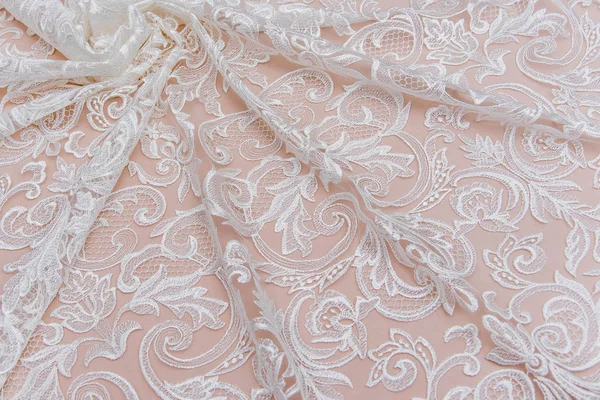 Texture lace fabric. lace on white background studio. thin fabric made of yarn or thread. a background image of ivory-colored lace cloth. White lace on beige background. — Stock Photo, Image