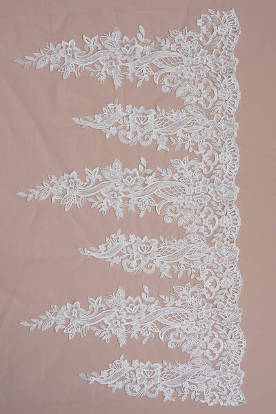 Texture lace fabric. lace on white background studio. thin fabric made of yarn or thread. a background image of ivory-colored lace cloth. White lace on beige background.