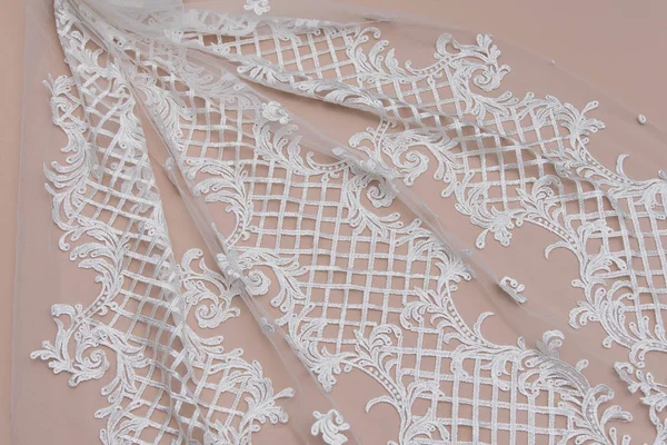 Texture lace fabric. lace on white background studio. thin fabric made of yarn or thread. a background image of ivory-colored lace cloth. White lace on beige background. — Stock Photo, Image