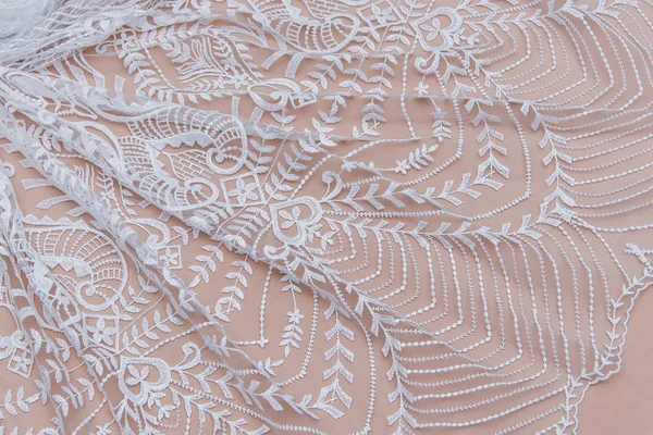 Texture lace fabric. lace on white background studio. thin fabric made of yarn or thread. a background image of ivory-colored lace cloth. White lace on beige background. — Stock Photo, Image