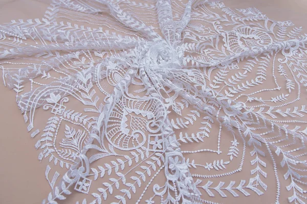 Texture lace fabric. lace on white background studio. thin fabric made of yarn or thread. a background image of ivory-colored lace cloth. White lace on beige background. — Stock Photo, Image