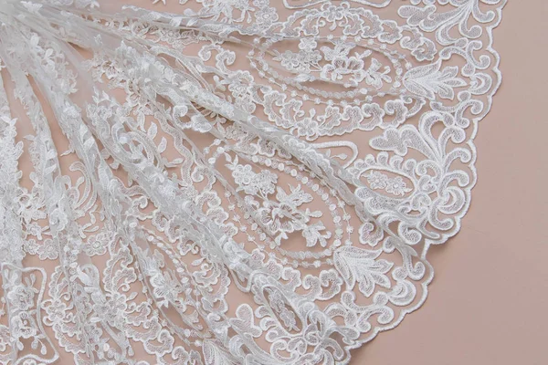 Texture lace fabric. lace on beige background studio. thin fabric made of yarn or thread. typically one of cotton or silk, made by looping, twisting, or knitting thread in patterns — Stock Photo, Image