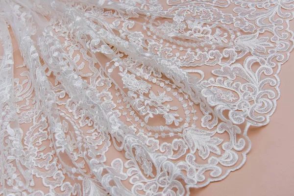 Texture lace fabric. lace on beige background studio. thin fabric made of yarn or thread. typically one of cotton or silk, made by looping, twisting, or knitting thread in patterns — Stock Photo, Image