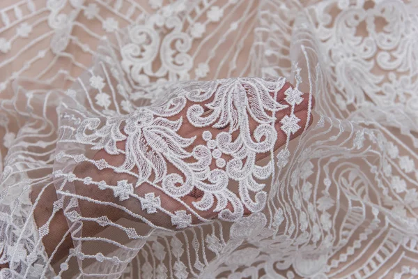 Texture lace fabric. lace on white background studio. thin fabric made of yarn or thread. a background image of ivory-colored lace cloth. White lace on beige background. — Stock Photo, Image