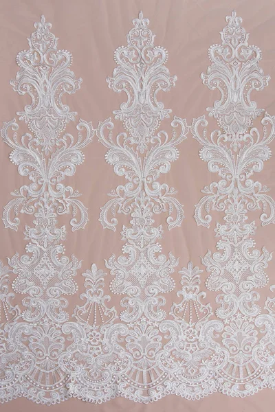 Texture lace fabric. lace on white background studio. thin fabric made of yarn or thread. a background image of ivory-colored lace cloth. White lace on beige background. — Stock Photo, Image