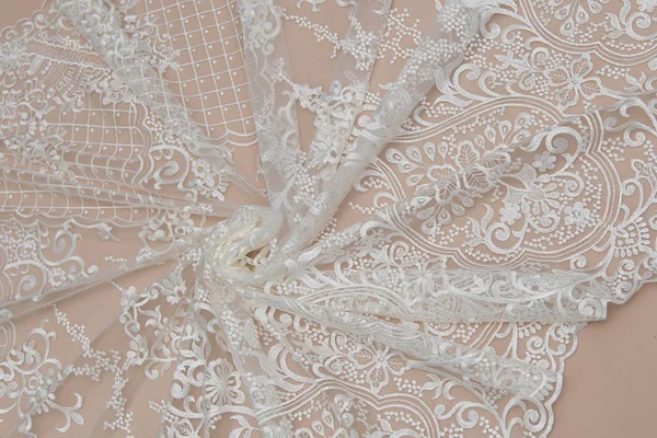 Texture lace fabric. lace on white background studio. thin fabric made of yarn or thread. a background image of ivory-colored lace cloth. White lace on beige background. — Stock Photo, Image