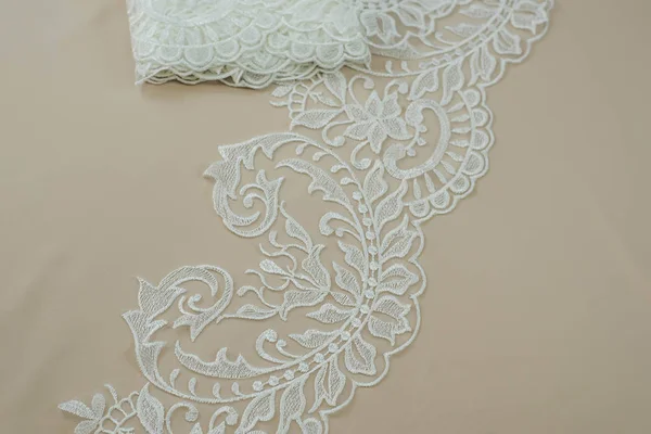 Texture lace fabric. lace on white background studio. thin fabric made of yarn or thread. a background image of ivory-colored lace cloth. White lace on beige background. — Stock Photo, Image