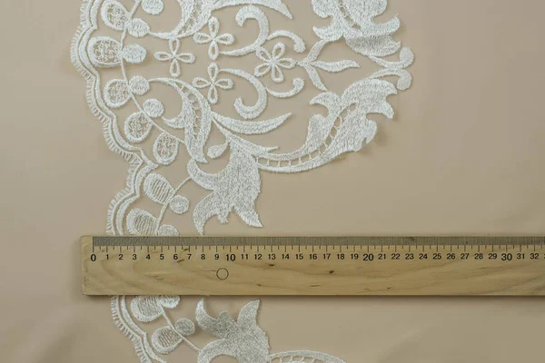 Texture lace fabric. lace on white background studio. thin fabric made of yarn or thread. a background image of ivory-colored lace cloth. White lace on beige background. — Stock Photo, Image