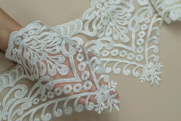 Texture lace fabric. lace on white background studio. thin fabric made of yarn or thread. a background image of ivory-colored lace cloth. White lace on beige background. — Stock Photo, Image