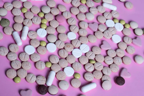harmaceuticals antibiotics pills medicine /colorful antibacterials pills on pink background /capsule pill medicine. Creative idea. Drugs. Sad. Die. Illness