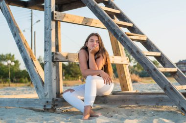 Summer holiday fashion concept. Cute young teenage girl on a tropical beach. Summer vacation concept. Plus size model